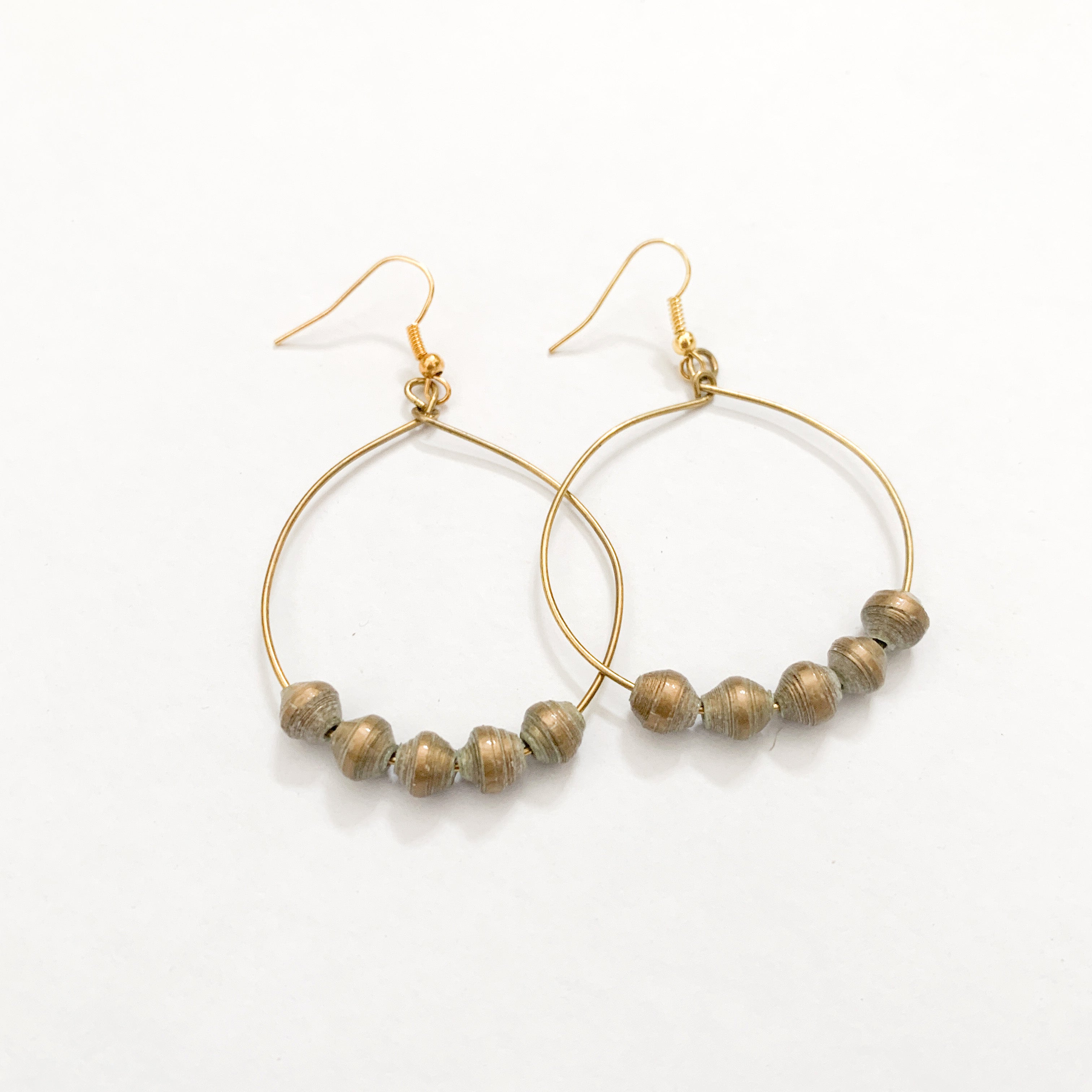 JustOne's brass hoop earrings with five gold paper beads on the bottom of the hoop, handcrafted in Uganda