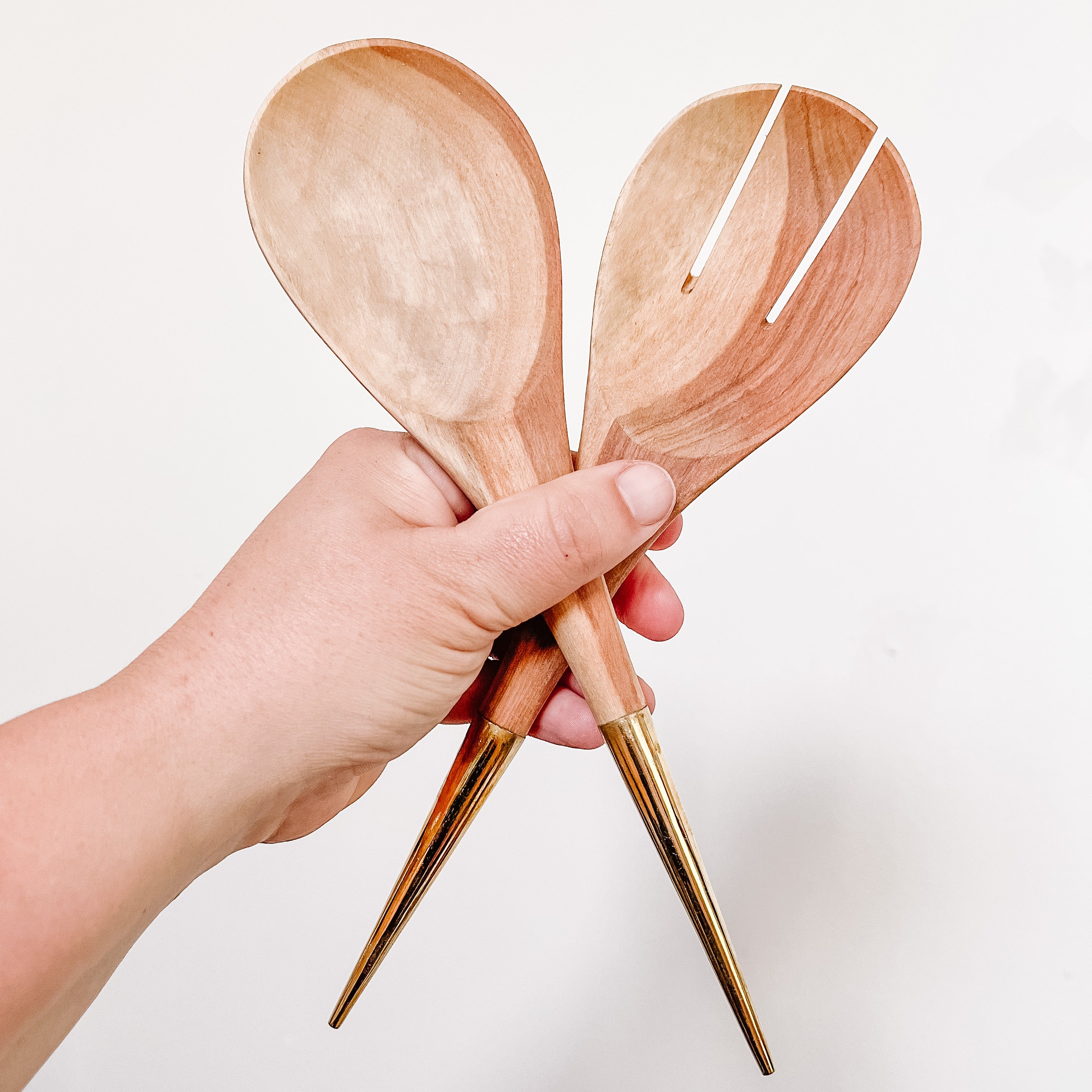 JustOne's handcrafted wooden salad spoons with a handle made of brass that comes to a point, made in Kenya