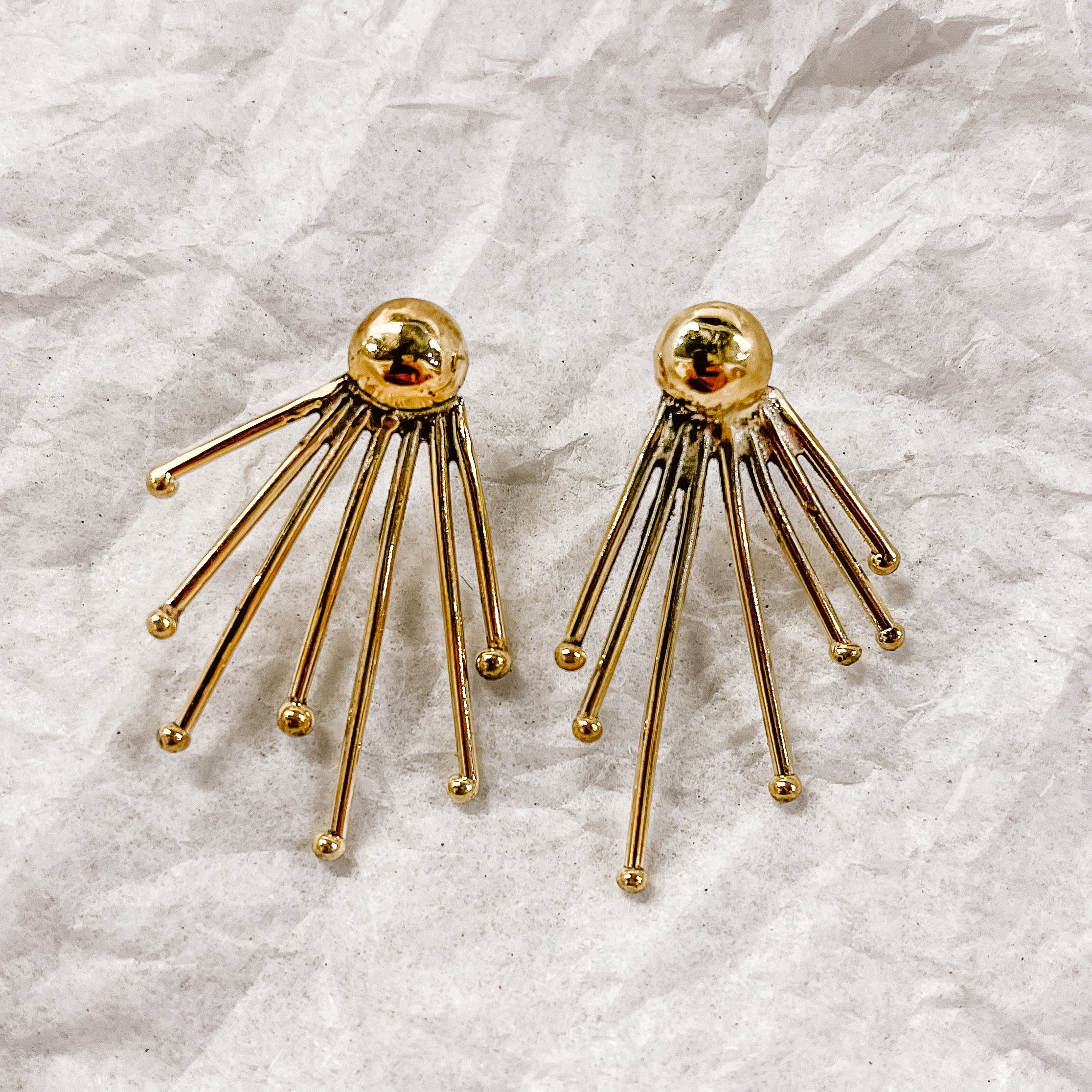 JustOne's brass earrings with lines coming out of the stud to resemble sunshine, handcrafted in Kenya
