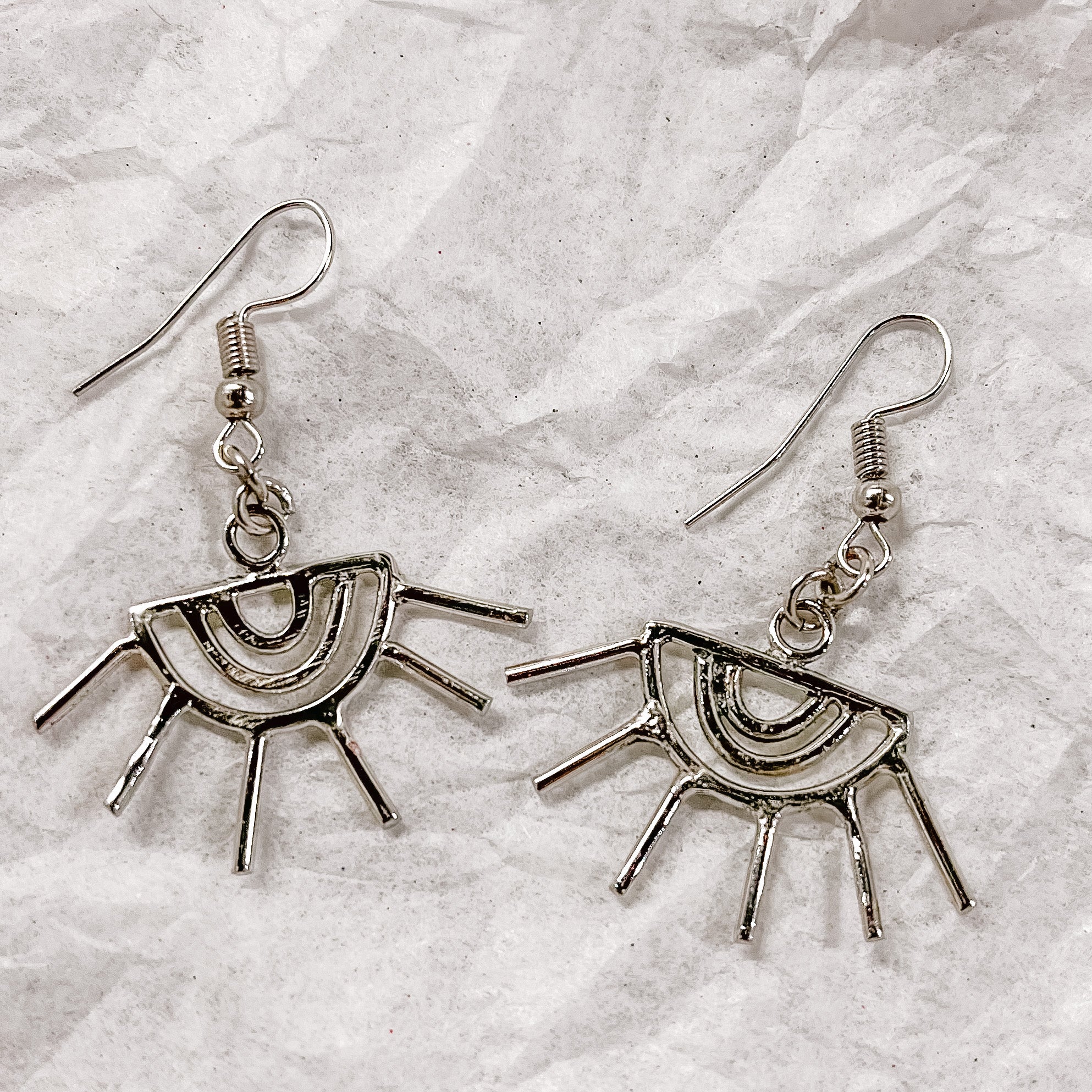 JustOne's silver eye shaped earrings with eyelashes sticking out of the earring, handcrafted in Kenya