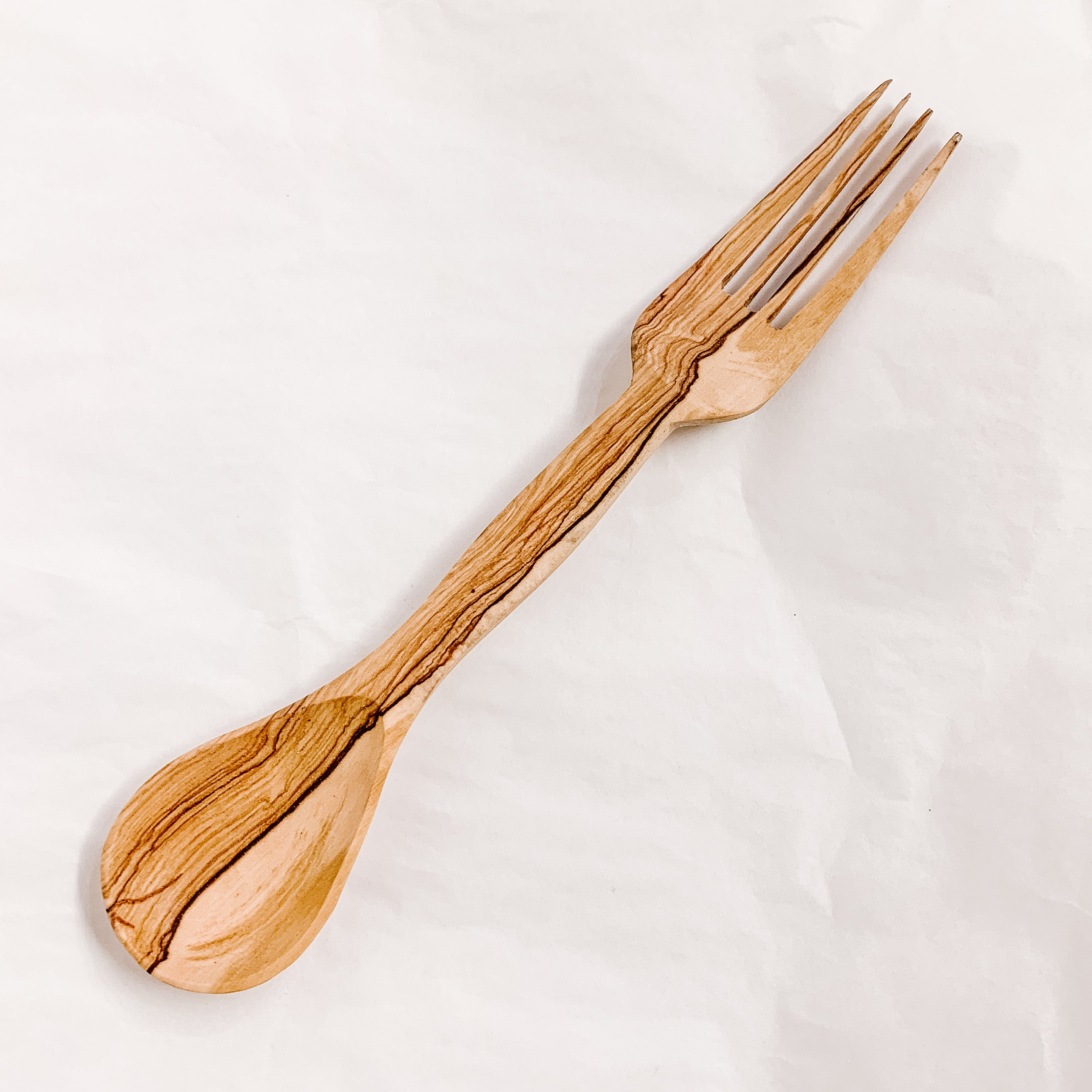 JustOne's spork with one side as a spoon and the other as a fork, handcrafted from wood in Kenya