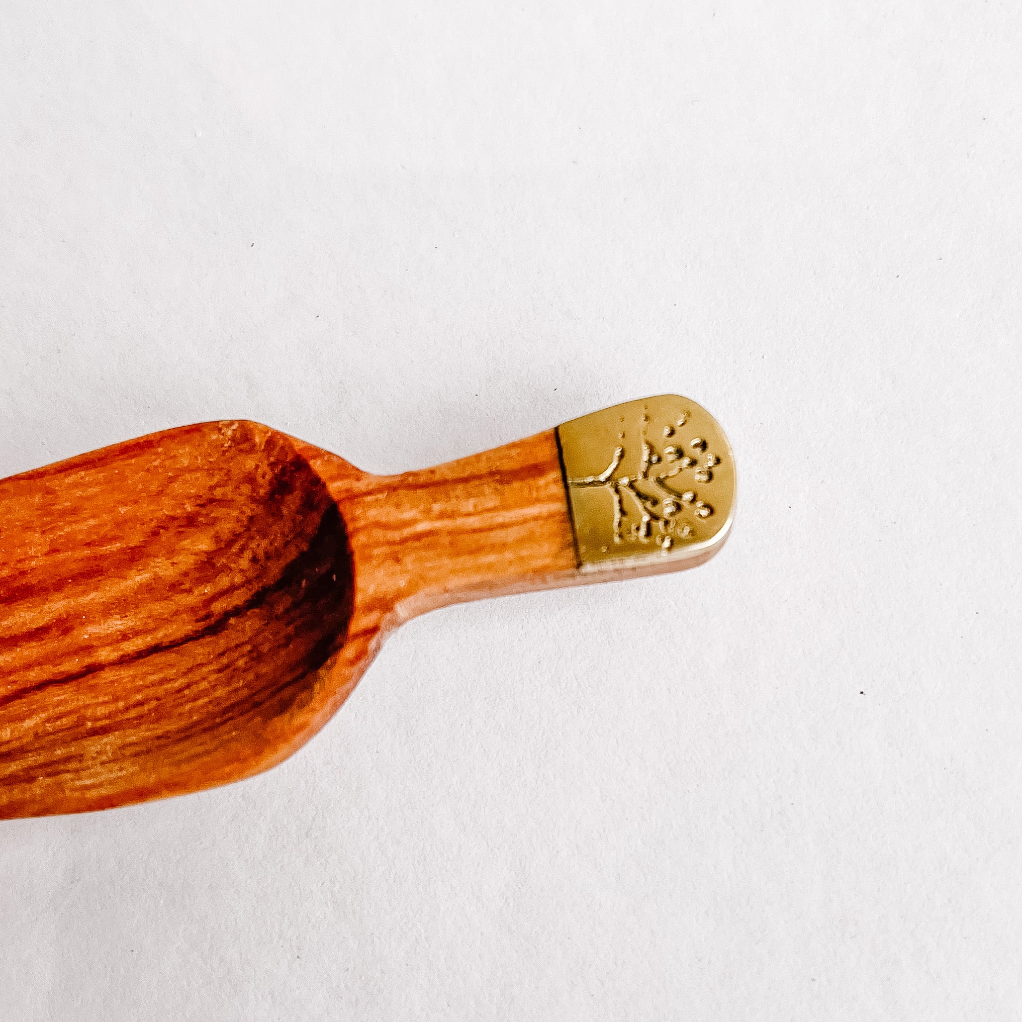 JustOne's four inch wooden scoop with a tree engraved recycled brass handle, handcrafted in Kenya
