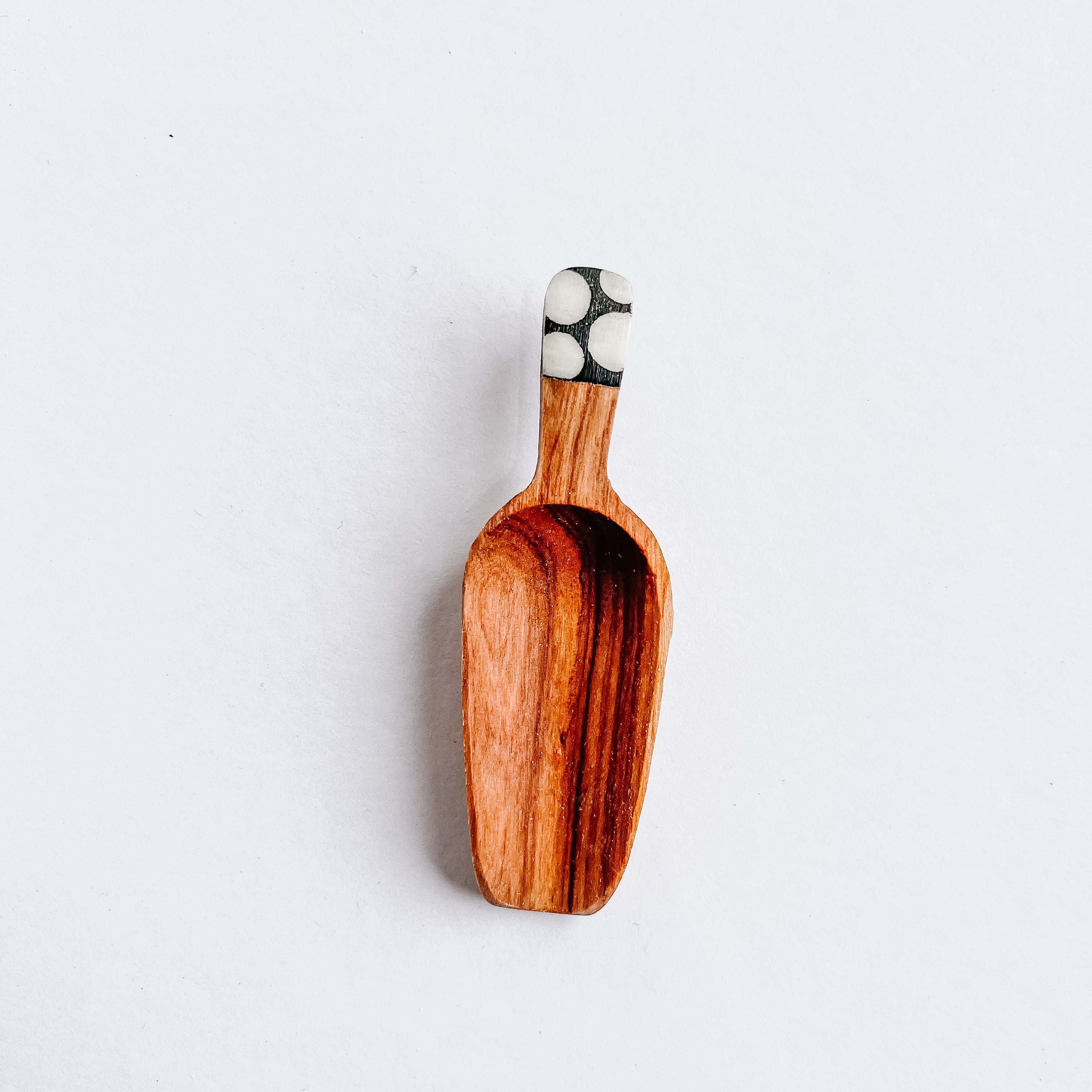 JustOne's four inch wooden scoop with polka dot handle made from ethically sourced bone, handcrafted in Uganda